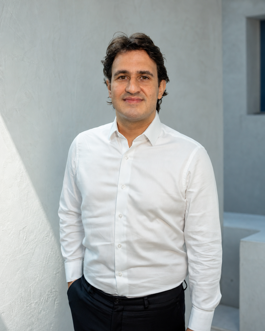 Studio portrait of Guilherme Giron wearing a white shirt